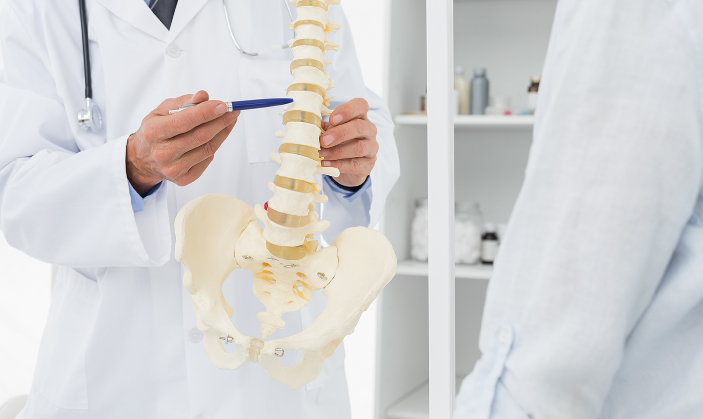 Chiropractor examining spine with disk problems